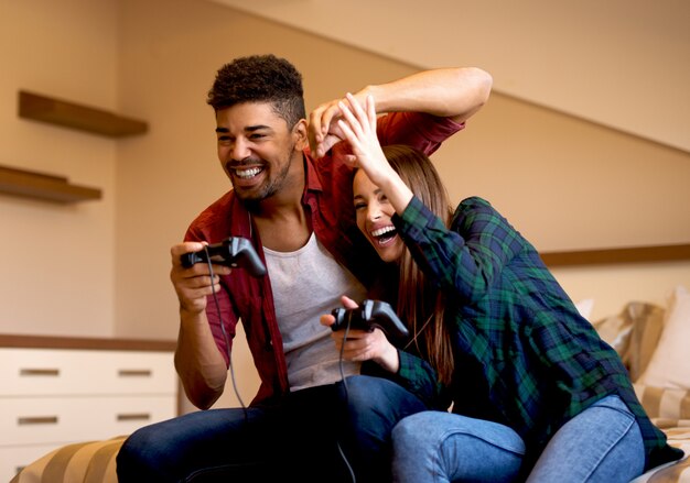 Couple s'amusant à la maison à jouer à des jeux.