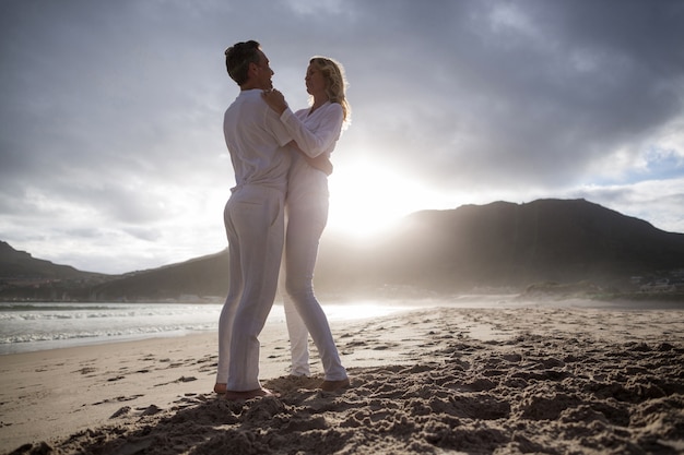 Couple senior s'amuser ensemble à la plage