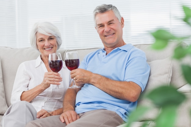 Couple tinter leurs verres de vin rouge