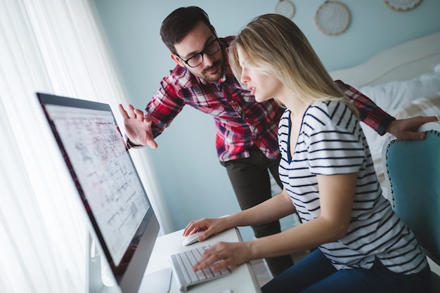 Couple travaillant ensemble sur un projet de démarrage à domicile