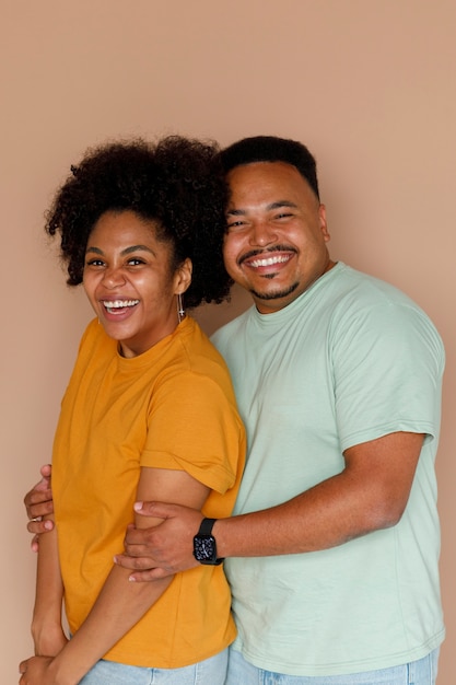 Photo couple vue de côté qui pose en studio