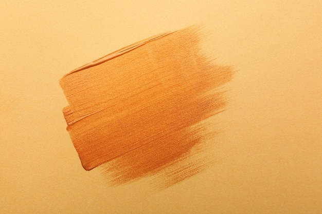 Coups de peinture or sur fond orange