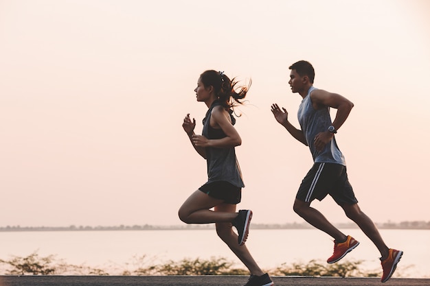 Coureur de jeune couple en cours d&#39;exécution sur la route