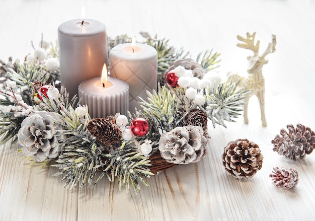 Couronne de l'Avent décorée de branches de sapin et de feuilles persistantes avec la tradition des bougies allumées avant Noël