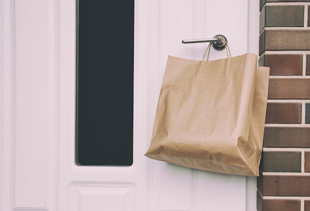 Le coursier a laissé la commande dans un emballage papier sur la poignée de la porte