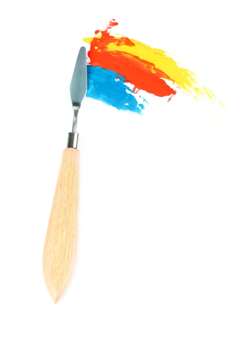 Photo couteau à palette de peinture avec des peintures isolées sur blanc