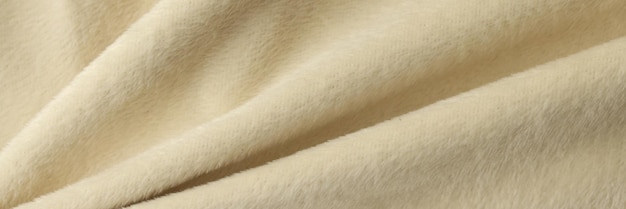 Couverture beige ondulée douce en arrière-plan textile beige proche