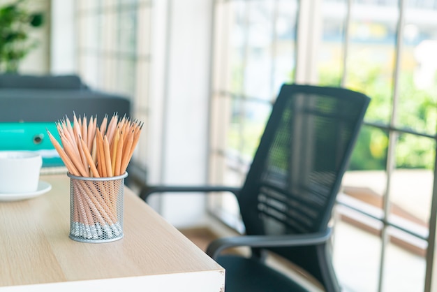 crayon en bois dans un porte-crayon sur une table de travail