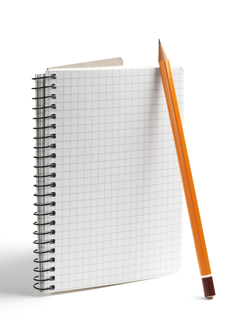 Photo crayon et cahier ouvert sur fond blanc