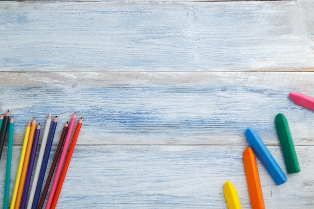 crayons de couleur et crayons de couleur sur un bois vintage éraflé bleu et blanc, vue de dessus