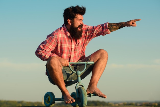 Crazy man riding a small bicycle Excited young male riding a small bicycle et gesticulant bonheur Y