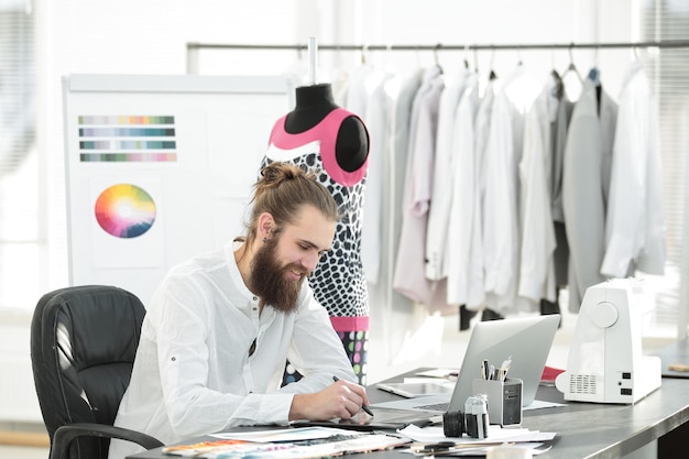 Photo le créateur de mode utilise une tablette graphique pour créer des croquis de vêtements