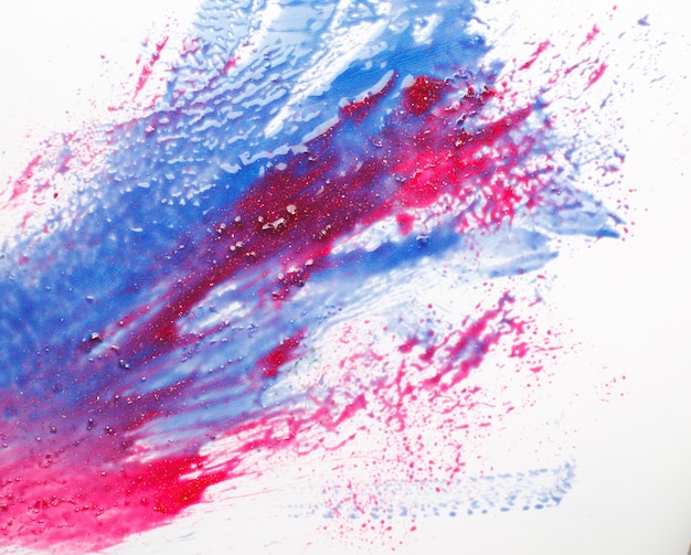 Créativité, art abstrait, peinture moderne. Couleurs bleues et rouges barbouillées sur fond blanc