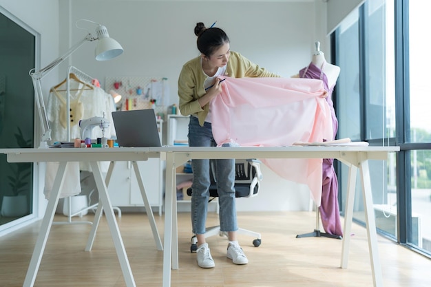 Créatrice de mode femme heureuse de concevoir des vêtements