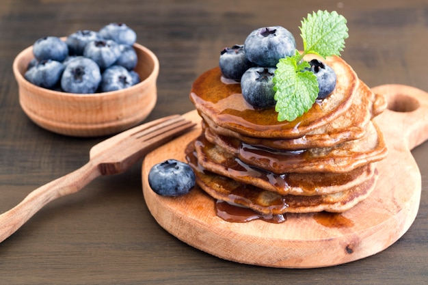 Crêpes au chocolat avec des myrtilles sur un fond sombre.