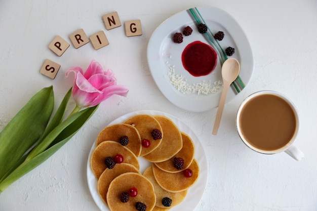 Crêpes Fleurs de café et inscription printanière sur fond blanc