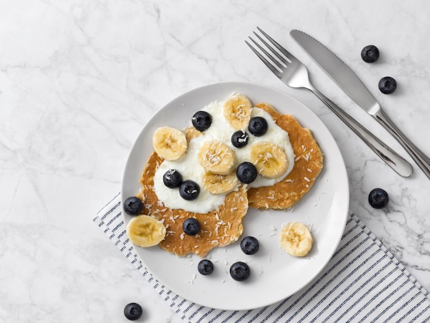 Crêpes saines avec des baies fraîches, des fruits et du yaourt. Concept de petit déjeuner d'été.