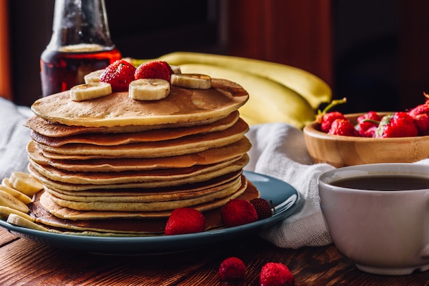 Crêpes avec tasse de thé et fruits