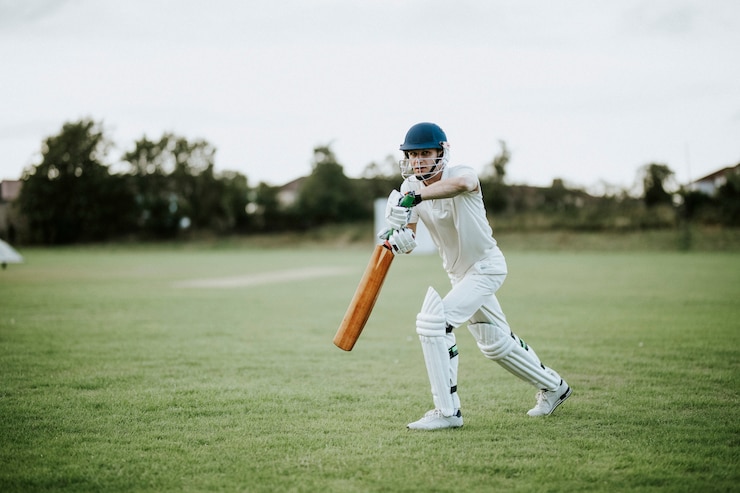 Photo cricketer sur le terrain en action
