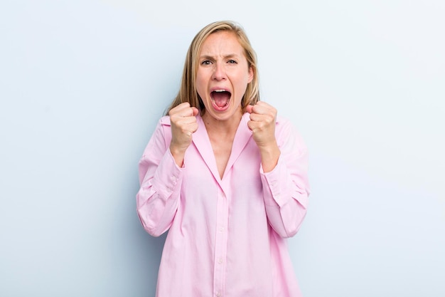 Crier de manière agressive avec un regard en colère agacé et frustré et des poings serrés se sentant furieux