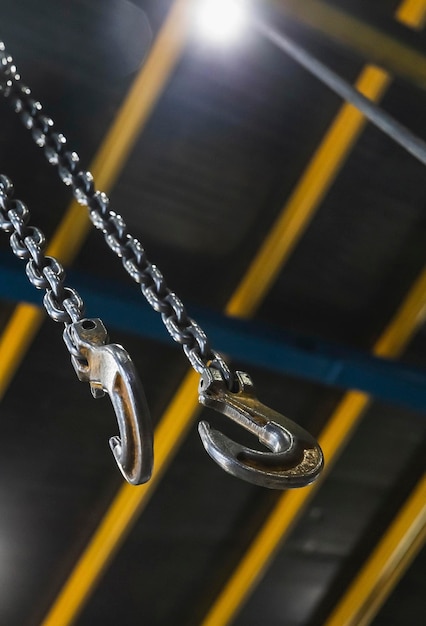 crochet en métal suspendu à une chaîne dans une usine se concentrer sur le crochet