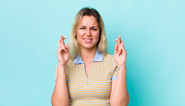 croisant les doigts avec anxiété et espérant bonne chance avec un regard inquiet