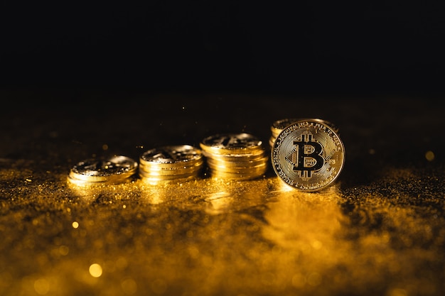 Croissance du bitcoin, pièces de monnaie bitcoin empilées sur fond d'or noir