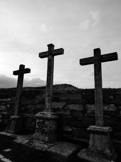 Croix au cimetière contre le ciel