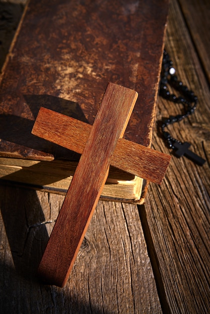 Croix chrétienne sur bible en bois et chapelet