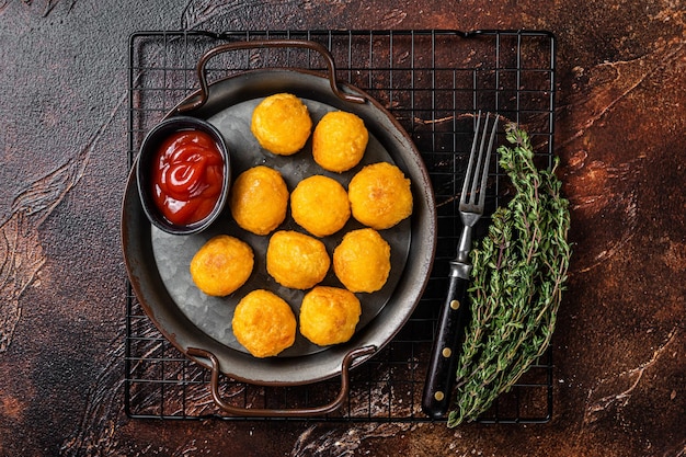 Croquettes de pommes de terre boulettes de purée de pommes de terre panées et frites Fond sombre Vue de dessus