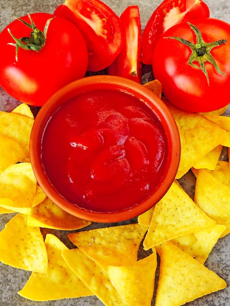 Photo croustilles jaunes triangulaires et sauce rouge aux tomates