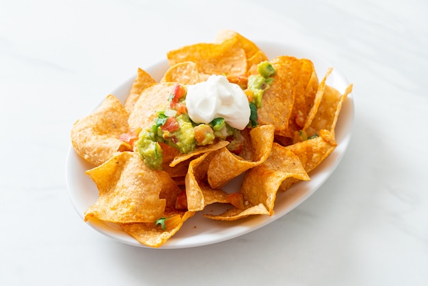 Croustilles de tortilla aux nachos mexicains avec jalapeño, guacamole, salsa de tomates et trempette