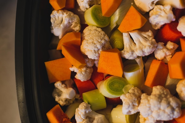 Crudités coupées en petits morceaux préparées pour la cuisson à la vapeur chou-fleur butternut poireau carotte