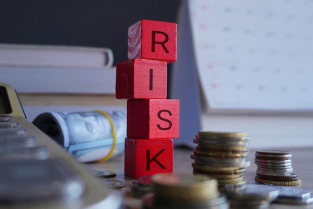 Photo cubes en bois avec texte calculateur de risque et argent conception financière et d'investissement du risque dans les entreprises