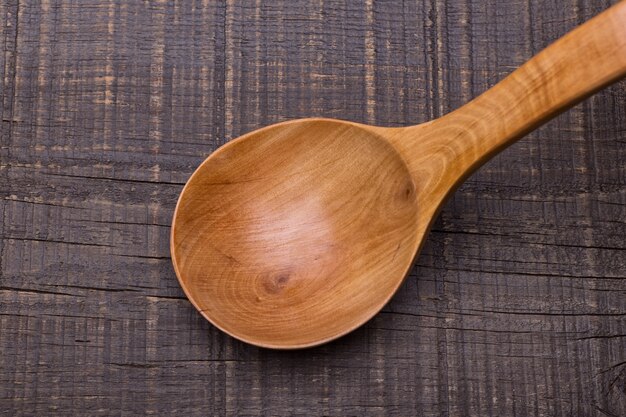 Cuillère en bois ancienne rustique. Sur la table.