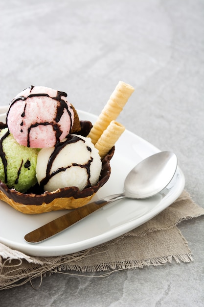 Cuillères à glace servies dans un panier à gaufres sur pierre grise