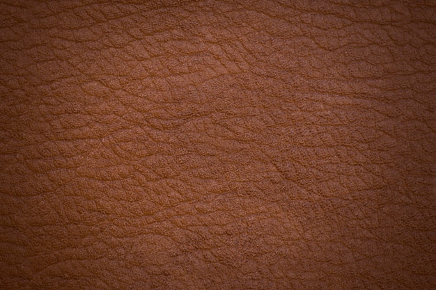 Photo cuir marron. surface texturée avec vignettage.