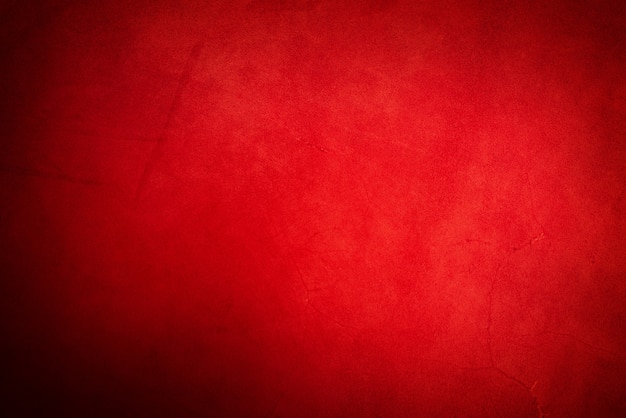 Cuir véritable rouge comme gros plan d'arrière-plan. Photographie horizontale d'une texture en daim.