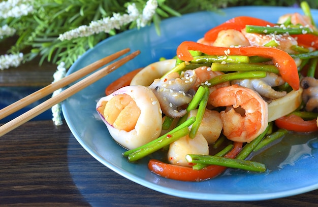 Cuisine asiatique aux fruits de mer, légumes à la sauce soja sur une assiette