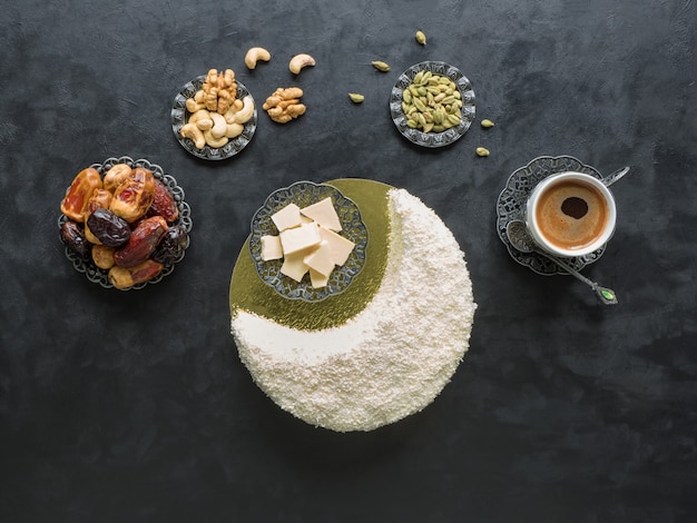 Cuisine festive Ramadan. Délicieux gâteau fait maison en forme de croissant de lune, servi avec dattes et tasse de café