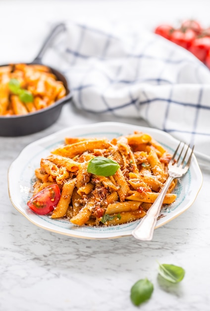 Cuisine italienne et pâtes pene avec sause bolognaise sur assiette.