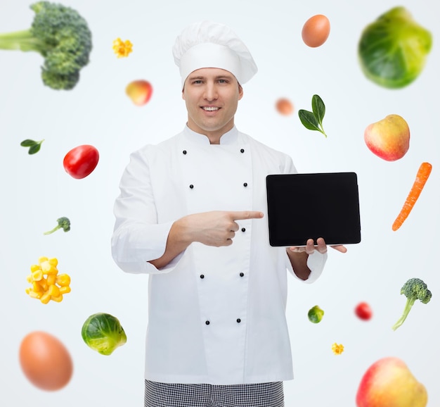 cuisine, profession, technologie, régime végétarien et concept de personnes - heureux chef cuisinier montrant un écran blanc noir d'ordinateur pc tablette