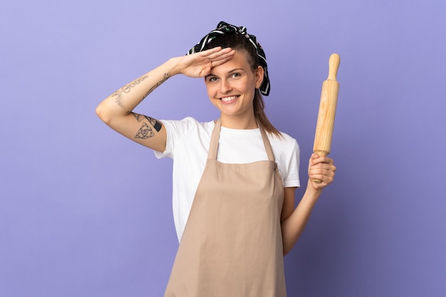 Photo cuisinière femme slovaque isolée sur fond violet saluant avec la main avec une expression heureuse