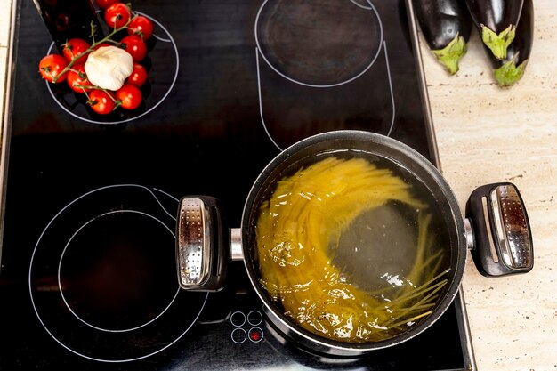 Cuisson de délicieux spaghettis dans de l'eau bouillante