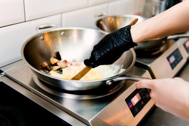 La cuisson des œufs brouillés dans une casserole en métal dans un café, mise au point sélective