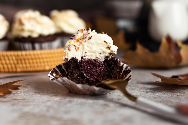 Cupcakes au chocolat dans un panier en osier Un cupcake coupé à la fourchette