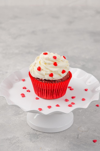 Des cupcakes en velours rouge avec du glaçage au fromage à la crème sont décorés pour l'espace de copie de la Saint-Valentin