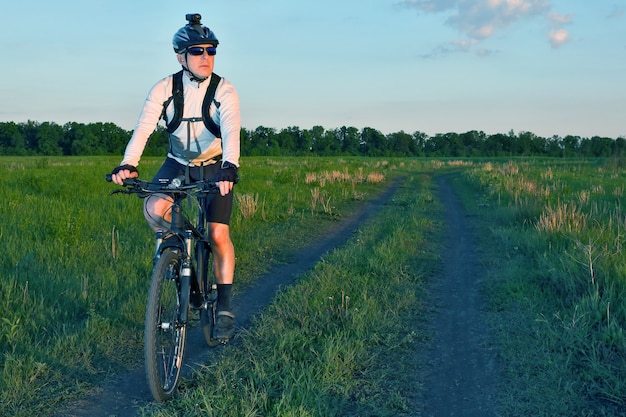 Cycliste roule sur la route sur le terrain