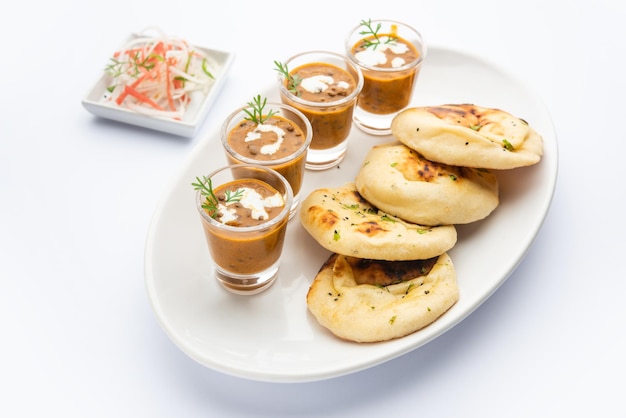 Dal Makhani ou dal makhni Shots avec du beurre et de la crème de haricots naan et servis avec du naan à l'ail ou du pain indien ou du roti