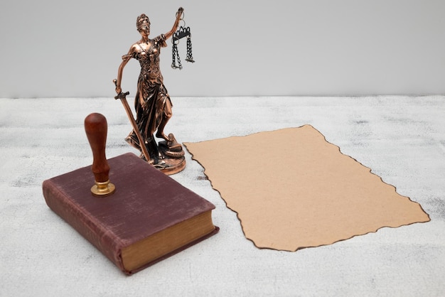 Dame Justice vieux livre et parchemin avec sceau et timbre sur une vieille table en bois Concept de droit et de justice